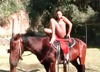 Slim woman takes off her clothes and shows off her body for a horse