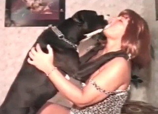 Naked whore is having some fun with a lovely black dog