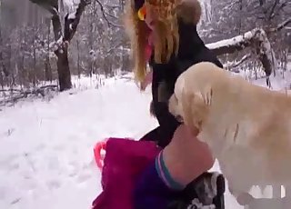Amateur with a blond hair fucking a dog in the snow